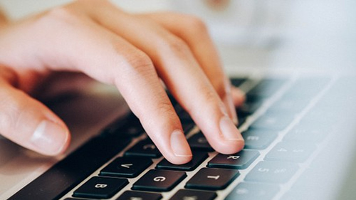 hand typing on keyboard