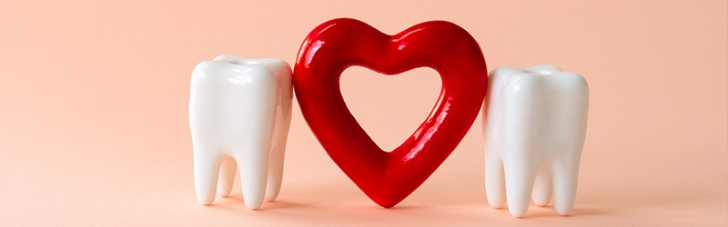 red heart shape between two teeth