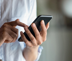 close up of woman holding phone in hand