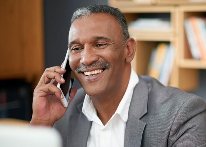 smiling African American man on mobile phone